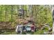 This waterfront home features a private boat dock, covered boat slip, and a custom boat with a slide for lake fun at 8191 S Bayview Ct, Trafalgar, IN 46181