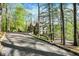 Long driveway leading to a well-maintained home with stone accents amidst lush trees and landscaping at 8191 S Bayview Ct, Trafalgar, IN 46181
