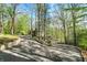 Scenic view of a long driveway winding through lush trees leading to a beautiful home at 8191 S Bayview Ct, Trafalgar, IN 46181