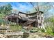 Stunning multi-story brick home nestled among trees with an elevated deck and stairway access at 8191 S Bayview Ct, Trafalgar, IN 46181