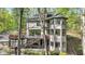 Exterior angle of a stunning multi-story home with a deck, staircase, and unique turret design at 8191 S Bayview Ct, Trafalgar, IN 46181