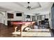 Game room with a pool table, wet bar, hardwood floors, and stone fireplace in background at 8191 S Bayview Ct, Trafalgar, IN 46181
