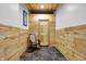 Inviting hallway featuring stylish wood paneled walls and unique stone tile flooring at 8191 S Bayview Ct, Trafalgar, IN 46181
