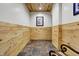 Rustic hallway with stone floors and wood paneling at 8191 S Bayview Ct, Trafalgar, IN 46181