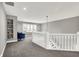 Bright landing area with carpet, white wood railing, and natural light at 8191 S Bayview Ct, Trafalgar, IN 46181
