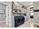 Well-organized laundry room with modern washer, dryer, and ample storage cabinets at 8191 S Bayview Ct, Trafalgar, IN 46181