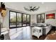 Bright living room featuring a fireplace, modern lighting, and access to deck at 8191 S Bayview Ct, Trafalgar, IN 46181