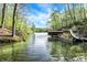 Serene lake view features a tree-lined shore and covered boat dock, perfect for nature lovers at 8191 S Bayview Ct, Trafalgar, IN 46181