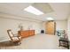 Basement rec room with laminate flooring, bright lighting, and storage cabinets and space for play and activities at 8332 Tanager Ln, Indianapolis, IN 46256