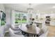 Elegant dining area with modern chandelier and views into the white kitchen at 8332 Tanager Ln, Indianapolis, IN 46256