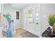 Bright, neutral foyer with a clear glass door and decorative vase at 8332 Tanager Ln, Indianapolis, IN 46256