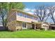Well-maintained home with a stone and siding exterior, lush lawn, and a neatly manicured front yard at 8332 Tanager Ln, Indianapolis, IN 46256