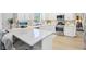 Bright kitchen featuring white cabinets, stainless steel appliances, and a stylish backsplash with a large island at 8332 Tanager Ln, Indianapolis, IN 46256
