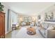 Inviting living room with ample seating, natural light, neutral tones and an open floor plan at 8332 Tanager Ln, Indianapolis, IN 46256
