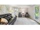 Cozy living room with a comfortable leather sofa, neutral walls, and abundant natural light at 8332 Tanager Ln, Indianapolis, IN 46256