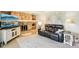 Open living area with a stone fireplace, neutral decor, and a large sofa for relaxation at 8332 Tanager Ln, Indianapolis, IN 46256