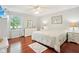 Serene main bedroom suite featuring hardwood floors, soft decor, and a large window with natural light at 8332 Tanager Ln, Indianapolis, IN 46256