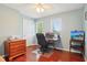 Bright home office featuring hardwood floors, a desk, and a comfortable chair at 8332 Tanager Ln, Indianapolis, IN 46256