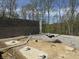 Concrete block foundation with plumbing and gravel work in progress on a wooded homesite at 8448 E Dobbs Cemetary Rd, Columbus, IN 47201