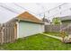 Spacious backyard featuring a well-kept lawn, wooden fence, and a detached garage, enhancing privacy and functionality at 926 Olive St, Indianapolis, IN 46203