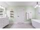 Spa-like bathroom with sleek fixtures, a soaking tub, decorative shelving, and a calming color palette at 926 Olive St, Indianapolis, IN 46203