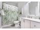 Charming bathroom with a leaf-patterned shower curtain and a white vanity for a serene, spa-like experience at 926 Olive St, Indianapolis, IN 46203