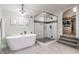 Elegant bathroom featuring a freestanding tub, glass-enclosed shower, and seamless entry to the walk-in closet at 926 Olive St, Indianapolis, IN 46203