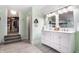 Stylish bathroom showcasing double vanity sinks, modern lighting, and convenient access to a walk-in closet at 926 Olive St, Indianapolis, IN 46203