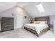 Charming bedroom with vaulted ceilings, skylight, and neutral decor; creates a serene and inviting atmosphere at 926 Olive St, Indianapolis, IN 46203
