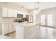 Modern kitchen features white cabinetry, stainless steel appliances, and an island with seating, great for entertaining at 926 Olive St, Indianapolis, IN 46203