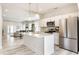 Open-concept kitchen with an island, stainless appliances, and a clear view to the dining and living spaces at 926 Olive St, Indianapolis, IN 46203