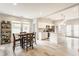 Bright, open kitchen with white cabinets, an island, and a dining area bathed in natural light at 926 Olive St, Indianapolis, IN 46203