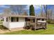 Side view of home with covered patio and mature landscaping at 9570 S 300 W, Columbus, IN 47201