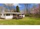 View of home's backyard with an older covered patio and mature trees at 9570 S 300 W, Columbus, IN 47201