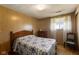Bedroom featuring a window, small dresser, and vintage chair at 9570 S 300 W, Columbus, IN 47201