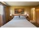 Comfortable bedroom showcasing a large bed and wood-paneled walls at 9570 S 300 W, Columbus, IN 47201
