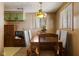 Cozy dining room with vintage light fixture, wood paneling, and seating for six at 9570 S 300 W, Columbus, IN 47201
