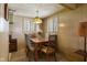 Quaint dining room featuring wood paneling, vintage light fixture, and natural light at 9570 S 300 W, Columbus, IN 47201