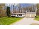 Charming single-story home with a two-car detached garage on a well-maintained lawn with trees at 9570 S 300 W, Columbus, IN 47201