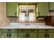 Vintage kitchen featuring olive-green cabinets and a view from the window over the sink at 9570 S 300 W, Columbus, IN 47201