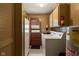 Utility room featuring a washer, dryer, and storage cabinets at 9570 S 300 W, Columbus, IN 47201
