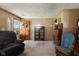 Comfortable living room with wood paneling, a floral wreath, and vintage furniture at 9570 S 300 W, Columbus, IN 47201