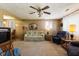 Spacious living room featuring wood paneling, vintage furniture, and ample lighting at 9570 S 300 W, Columbus, IN 47201