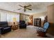 Inviting living room with comfortable seating, wood paneling, and natural light at 9570 S 300 W, Columbus, IN 47201