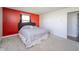 A brightly painted bedroom with a large window and neutral carpeting at 1004 Shepherd Rd, Anderson, IN 46012