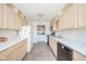 Well-lit kitchen featuring wood cabinetry, black appliances, and white countertops at 1004 Shepherd Rd, Anderson, IN 46012