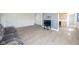 Open-concept living room with light floors, gray walls, and adjacent kitchen space at 1004 Shepherd Rd, Anderson, IN 46012