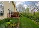 Backyard with lush green lawn, beautiful landscaping, and a charming patio at 1032 Grovewood Dr # 0, Beech Grove, IN 46107