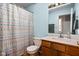 Bright bathroom featuring classic fixtures, a patterned shower curtain, and wood-finished vanity at 1032 Grovewood Dr # 0, Beech Grove, IN 46107