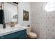 Stylish powder room with a geometric wallpaper, modern sink, and gold-tone fixtures at 1032 Grovewood Dr # 0, Beech Grove, IN 46107